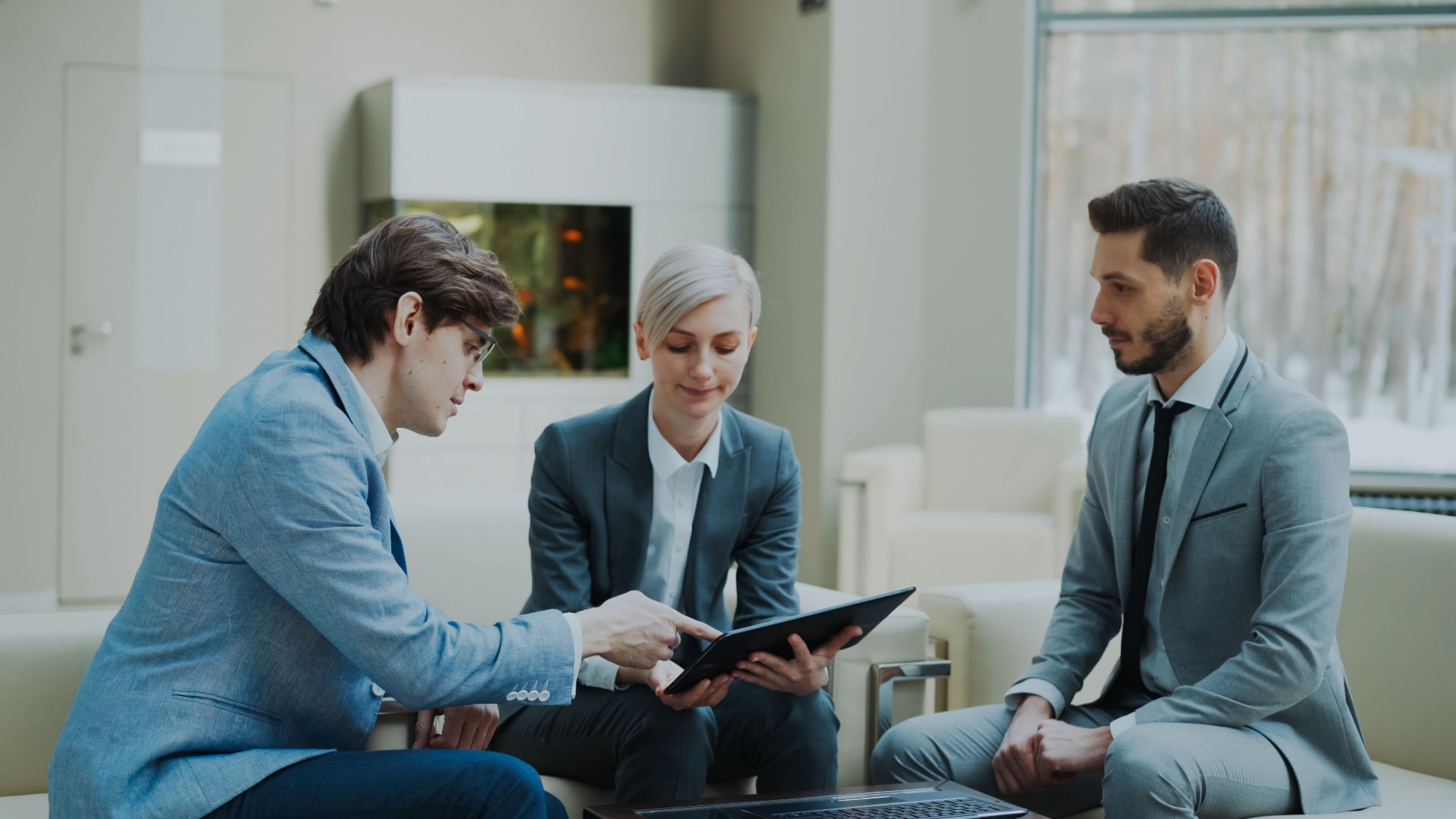 Business advisors reviewing financials together on a tablet
